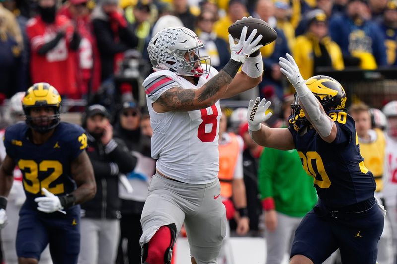 Nov 25, 2023; Ann Arbor, Michigan, USA; Ohio State Buckeyes tight end Cade Stover (8) catches a pass over Michigan Wolverines linebacker Jimmy Rolder (30) during the first half of the NCAA football game at Michigan Stadium. Mandatory Credit: Adam Cairns-USA TODAY Sports