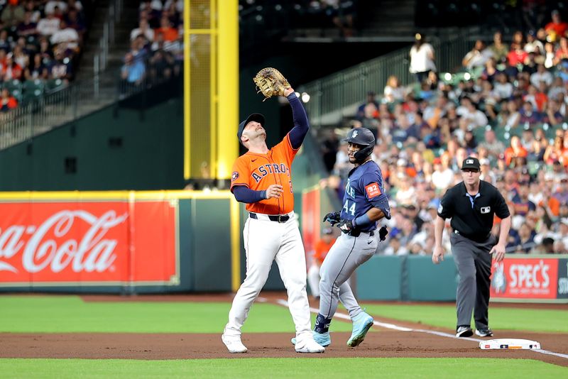 May 23, 2025; Houston, Texas, USA; Houston Astros first baseman Christian Walker (8) reaches up to catch a fly ball for an out against the Seattle Mariners during the first inning at Daikin Park. Mandatory Credit: Erik Williams-Imagn Images