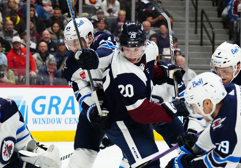 Dec 7, 2023; Denver, Colorado, USA; Colorado Avalanche center Ross Colton (20) and Winnipeg Jets defenseman Logan Stanley (64) during the second period at Ball Arena. Mandatory Credit: Ron Chenoy-USA TODAY Sports