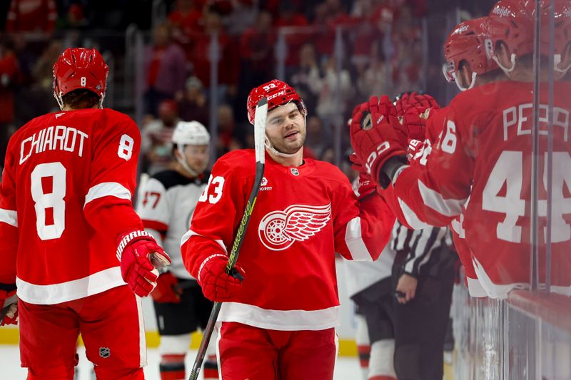 Oct 24, 2024; Detroit, Michigan, USA;  Detroit Red Wings right wing Alex DeBrincat (93) receives congratulations from teammates after scoring in the first period against the New Jersey Devils at Little Caesars Arena. Mandatory Credit: Rick Osentoski-Imagn Images