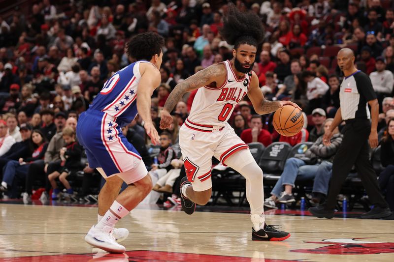 CHICAGO, ILLINOIS - DECEMBER 08: Coby White #0 of the Chicago Bulls drives to the basket against Jared McCain #20 of the Philadelphia 76ers during the second half at the United Center on December 08, 2024 in Chicago, Illinois. NOTE TO USER: User expressly acknowledges and agrees that, by downloading and or using this photograph, User is consenting to the terms and conditions of the Getty Images License Agreement.  (Photo by Michael Reaves/Getty Images)