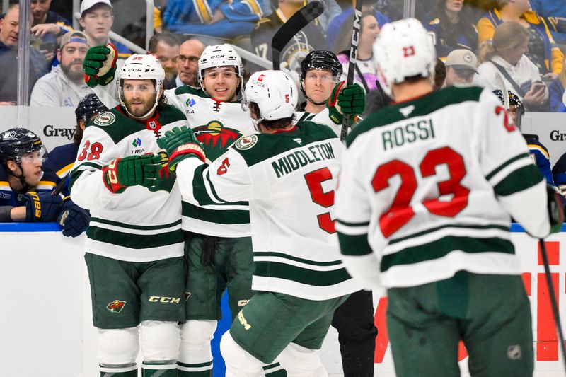 Nov 19, 2024; St. Louis, Missouri, USA;  Minnesota Wild right wing Ryan Hartman (38) is congratulated by teammates after scoring against the St. Louis Blues during the first period at Enterprise Center. Mandatory Credit: Jeff Curry-Imagn Images