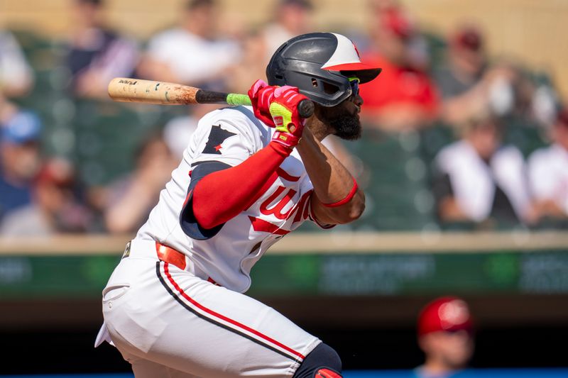 Sep 15, 2024; Minneapolis, Minnesota, USA; Minnesota Twins center fielder Willi Castro (50) hits a single against the Cincinnati Reds in the first inning at Target Field. Mandatory Credit: Jesse Johnson-Imagn Images