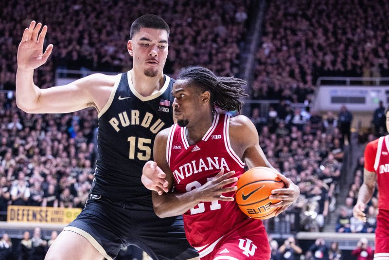 Feb 10, 2024; West Lafayette, Indiana, USA; Indiana Hoosiers forward Mackenzie Mgbako (21) dribbles the ball while Purdue Boilermakers center Zach Edey (15) defends in the first half at Mackey Arena. Mandatory Credit: Trevor Ruszkowski-USA TODAY Sports