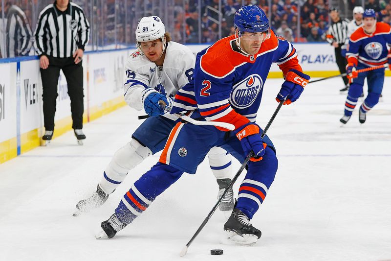 Jan 16, 2024; Edmonton, Alberta, CAN; Edmonton Oilers defensemen Evan Bouchard (2) protects the puck from Toronto Maple Leafs forward William Nylander (88) during the second period at Rogers Place. Mandatory Credit: Perry Nelson-USA TODAY Sports