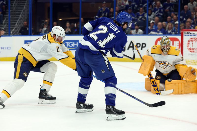 Oct 10, 2023; Tampa, Florida, USA; Tampa Bay Lightning center Brayden Point (21) shoots on Nashville Predators goaltender Juuse Saros (74) during the first period at Amalie Arena. Mandatory Credit: Kim Klement Neitzel-USA TODAY Sports