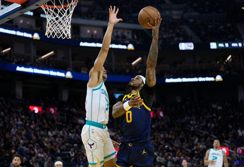 SAN FRANCISCO, CALIFORNIA - FEBRUARY 23: Bryce McGowens #7 of the Charlotte Hornets goes up to block the shot of Gary Payton II #0 of the Golden State Warriors in the first quarter at Chase Center on February 23, 2024 in San Francisco, California. NOTE TO USER: User expressly acknowledges and agrees that, by downloading and or using this photograph, User is consenting to the terms and conditions of the Getty Images License Agreement. (Photo by Thearon W. Henderson/Getty Images)