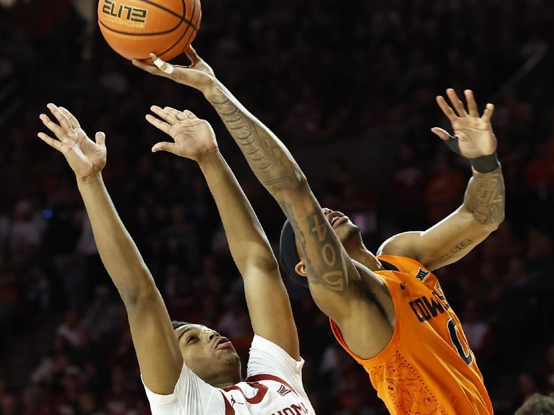 Feb 1, 2023; Norman, Oklahoma, USA; Oklahoma State Cowboys guard Avery Anderson III (0) shoots as Oklahoma State Cowboys forward Bernard Kouma (25) defends during the first half at Lloyd Noble Center. Mandatory Credit: Alonzo Adams-USA TODAY Sports