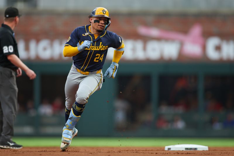 Aug 6, 2024; Atlanta, Georgia, USA; Milwaukee Brewers catcher William Contreras (24) hits a triple against the Atlanta Braves in the first inning at Truist Park. Mandatory Credit: Brett Davis-USA TODAY Sports