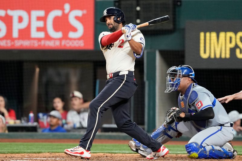 Jun 21, 2024; Arlington, Texas, USA; Texas Rangers second baseman Marcus Semien (2) follows through on his two-run double against the Kansas City Royals during the sixth inning at Globe Life Field. Mandatory Credit: Jim Cowsert-USA TODAY Sports