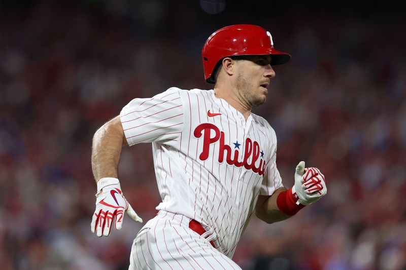 Oct 24, 2023; Philadelphia, Pennsylvania, USA; Philadelphia Phillies catcher J.T. Realmuto (10) runs to first bae after hitting a single against the Arizona Diamondbacks in the fourth inning for game seven of the NLCS for the 2023 MLB playoffs at Citizens Bank Park. Mandatory Credit: Bill Streicher-USA TODAY Sports