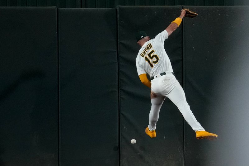 May 21, 2025; West Sacramento, California, USA; Athletics center fielder Seth Brown (15) is unable to catch the ball on a triple by Los Angeles Angels left fielder Taylor Ward (not pictured) in the eighth inning at Sutter Health Park. Mandatory Credit: Cary Edmondson-Imagn Images