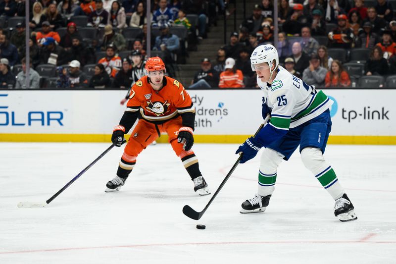 Nov 26, 2025; Anaheim, California, USA; Vancouver Canucks defenseman Elias Pettersson (25) controls the puck while under pressure from Anaheim Ducks right wing Frank Vatrano (77) during the second period at Honda Center. Mandatory Credit: William Liang-Imagn Images