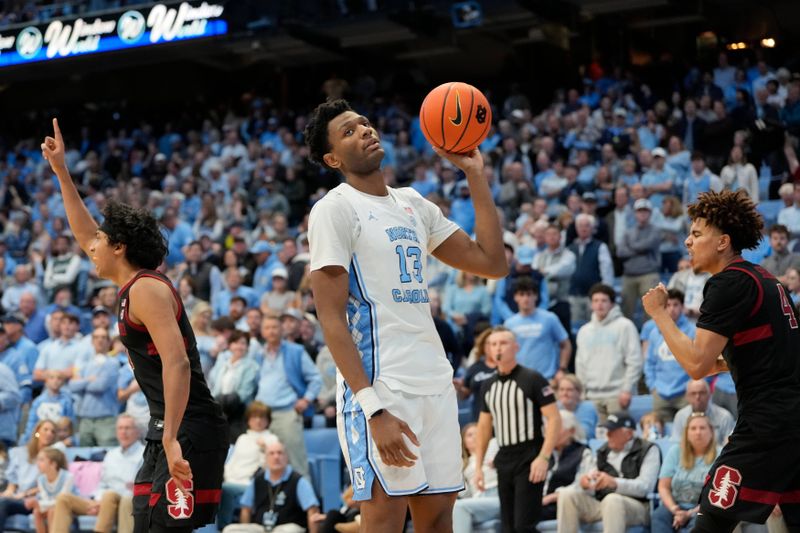 Jan 18, 2025; Chapel Hill, North Carolina, USA; Stanford Cardinal guard Ryan Agarwal (11) and guard Oziyah Sellers (4) react at the end of the game as North Carolina Tar Heels forward Jalen Washington (13) holds the ball at Dean E. Smith Center. Mandatory Credit: Bob Donnan-Imagn Images