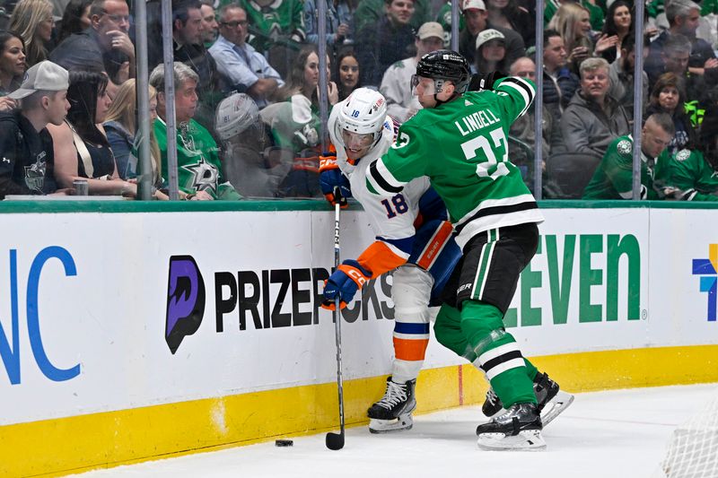 Feb 26, 2024; Dallas, Texas, USA; Dallas Stars defenseman Esa Lindell (23) checks New York Islanders left wing Pierre Engvall (18) during the first period at the American Airlines Center. Mandatory Credit: Jerome Miron-USA TODAY Sports