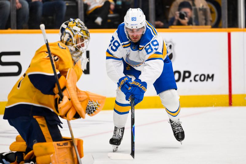 Feb 2, 2026; Nashville, Tennessee, USA;  Nashville Predators goaltender Juuse Saros (74) blocks the shot of St. Louis Blues left wing Pavel Buchnevich (89) during the first period at Bridgestone Arena. Mandatory Credit: Steve Roberts-Imagn Images