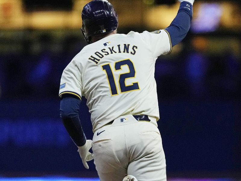 Jun 24, 2024; Milwaukee, Wisconsin, USA;  Milwaukee Brewers first baseman Rhys Hoskins (12) rounds the bases  after hitting a grand slam home run during the sixth inning against the Texas Rangers at American Family Field. Mandatory Credit: Jeff Hanisch-USA TODAY Sports