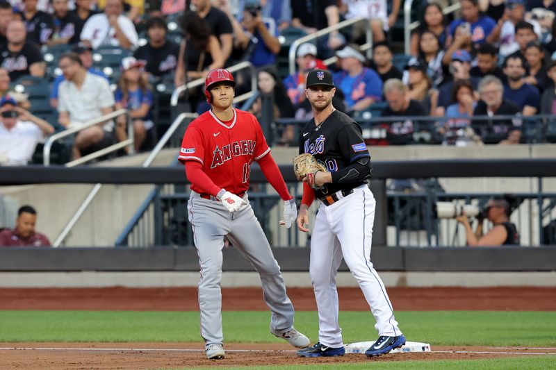 Aug 25, 2023; New York City, New York, USA; Los Angeles Angels designated hitter Shohei Ohtani (17) takes a lead off first base against New York Mets first baseman Pete Alonso (20) after walking during the first inning at Citi Field. Mandatory Credit: Brad Penner-USA TODAY Sports