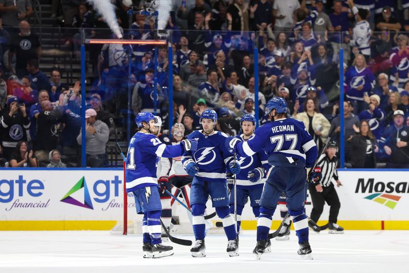 Mar 4, 2025; Tampa, Florida, USA; Tampa Bay Lightning defenseman Victor Hedman (77) celebrates with center Brayden Point (21) and left wing Brandon Hagel (38) after scoring a goal against the Columbus Blue Jackets in the third period at Amalie Arena. Mandatory Credit: Nathan Ray Seebeck-Imagn Images