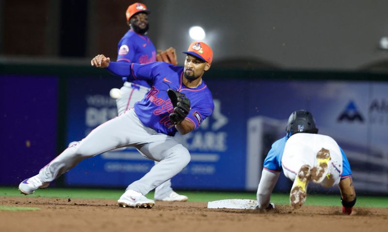 Mar 6, 2026; Jupiter, Florida, USA;  New York Mets second baseman Marcus Semien (10) tags out Miami Marlins shortstop Maximo Acosta (24) as he tries to steal second base during the second inning at Roger Dean Chevrolet Stadium. Mandatory Credit: Rhona Wise-Imagn Images