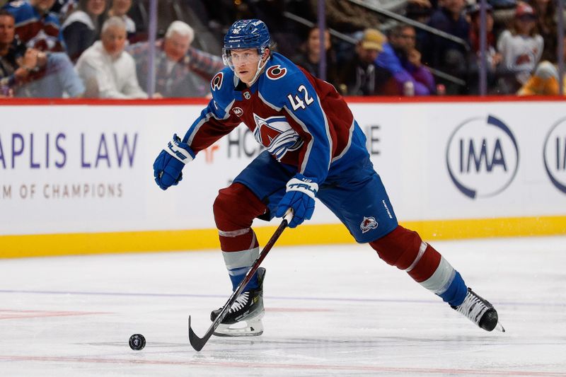 Oct 14, 2024; Denver, Colorado, USA; Colorado Avalanche defenseman Josh Manson (42) controls the puck in the second period against the New York Islanders at Ball Arena. Mandatory Credit: Isaiah J. Downing-Imagn Images