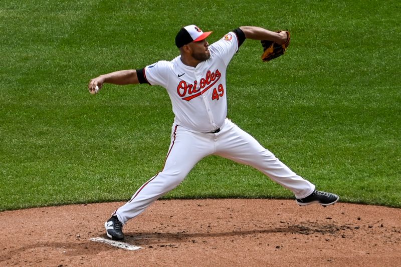 Sep 22, 2024; Baltimore, Maryland, USA;  Baltimore Orioles major league coach José Hernández (59) throws a second inning pitch against the Detroit Tigers at Oriole Park at Camden Yards. Mandatory Credit: Tommy Gilligan-Imagn Images