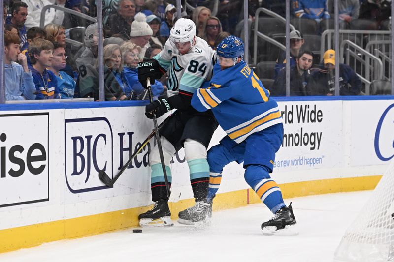 Nov 8, 2025; St. Louis, Missouri, USA; Seattle Kraken right wing Kaapo Kakko (84) and St. Louis Blues defenseman Cam Fowler (17) battle for the puck in the third period at Enterprise Center. Mandatory Credit: Joe Puetz-Imagn Images