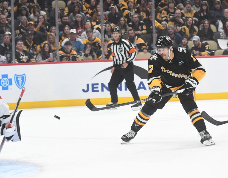 Nov 16, 2023; Pittsburgh, Pennsylvania, USA; Pittsburgh Penguins right wing Bryan Rust (17) scores on New Jersey Devils goalie Vitek Vance (41) during the first period at PPG Paints Arena. Mandatory Credit: Philip G. Pavely-USA TODAY Sports