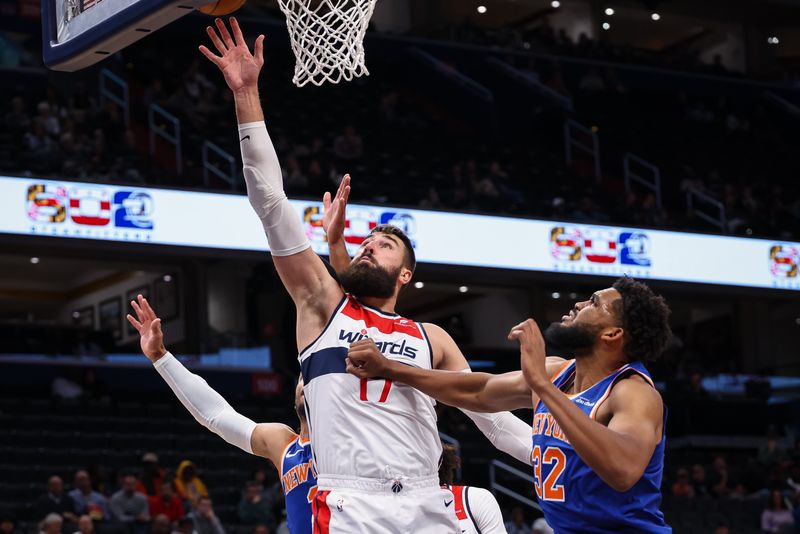 WASHINGTON, DC - OCTOBER 18: Jonas Valanciunas #17 of the Washington Wizards shoots the ball against Karl-Anthony Towns #32 of the New York Knicks during the first half of the preseason game at Capital One Arena on October 18, 2024 in Washington, DC. NOTE TO USER: User expressly acknowledges and agrees that, by downloading and or using this photograph, User is consenting to the terms and conditions of the Getty Images License Agreement. (Photo by Scott Taetsch/Getty Images)