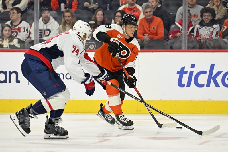 Feb 3, 2026; Philadelphia, Pennsylvania, USA; Philadelphia Flyers right wing Nikita Grebenkin (29) takes a shot while being defended by Washington Capitals defenseman John Carlson (74) during the first period at Xfinity Mobile Arena. Mandatory Credit: Eric Hartline-Imagn Images