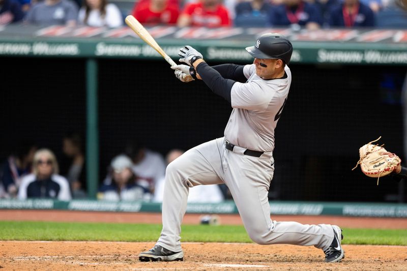 Apr 14, 2024; Cleveland, Ohio, USA; New York Yankees first baseman Anthony Rizzo (48) hits a two-run RBI single during the tenth inning against the Cleveland Guardians at Progressive Field. Mandatory Credit: Scott Galvin-USA TODAY Sports