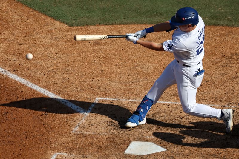 Oct 14, 2024; Los Angeles, California, USA; Los Angeles Dodgers outfielder Tommy Edman (25) hits a RBI single against the New York Mets in the sixth inning during game two of the NLCS for the 2024 MLB Playoffs at Dodger Stadium. Mandatory Credit: Kiyoshi Mio-Imagn Images