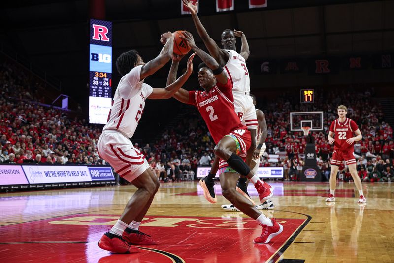 Feb 10, 2024; Piscataway, New Jersey, USA; Wisconsin Badgers guard AJ Storr (2) drives to the basket against Rutgers Scarlet Knights guard Jeremiah Williams (25) and forward Mawot Mag (3) during the first half at Jersey Mike's Arena. Mandatory Credit: Vincent Carchietta-USA TODAY Sports