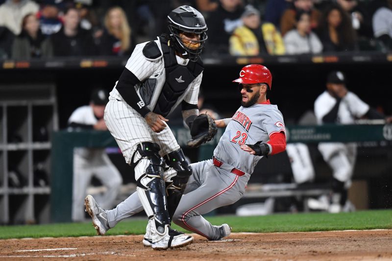 Apr 12, 2024; Chicago, Illinois, USA; Cincinnati Reds designated hitter Nick Martini (23) slides into home plate to score during the sixth inning against the Chicago White Sox at Guaranteed Rate Field. Mandatory Credit: Patrick Gorski-USA TODAY Sports