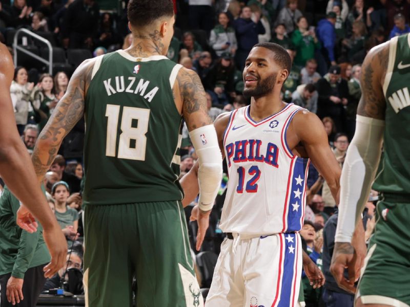 MILWAUKEE, WI - FEBRUARY 9: Kyle Kuzma #18 of the Milwaukee Bucks and Jared Butler #12 of the Philadelphia 76ers embrace after the game on February 9, 2025 at Fiserv Forum Center in Milwaukee, Wisconsin. NOTE TO USER: User expressly acknowledges and agrees that, by downloading and or using this Photograph, user is consenting to the terms and conditions of the Getty Images License Agreement. Mandatory Copyright Notice: Copyright 2025 NBAE(Photo by Gary Dineen/NBAE via Getty Images).