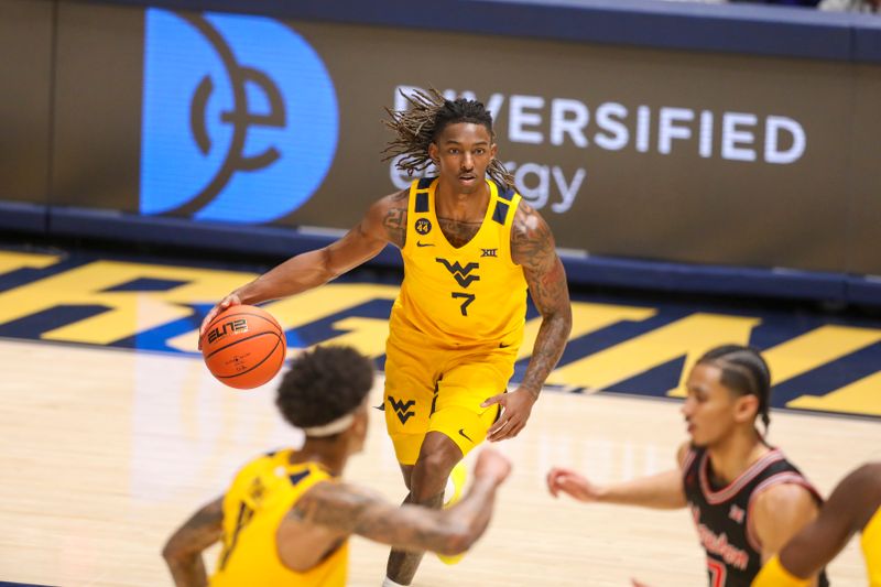 Jan 29, 2025; Morgantown, West Virginia, USA; West Virginia Mountaineers guard Javon Small (7) dribbles the ball during the first half against the Houston Cougars at WVU Coliseum. Mandatory Credit: Ben Queen-Imagn Images