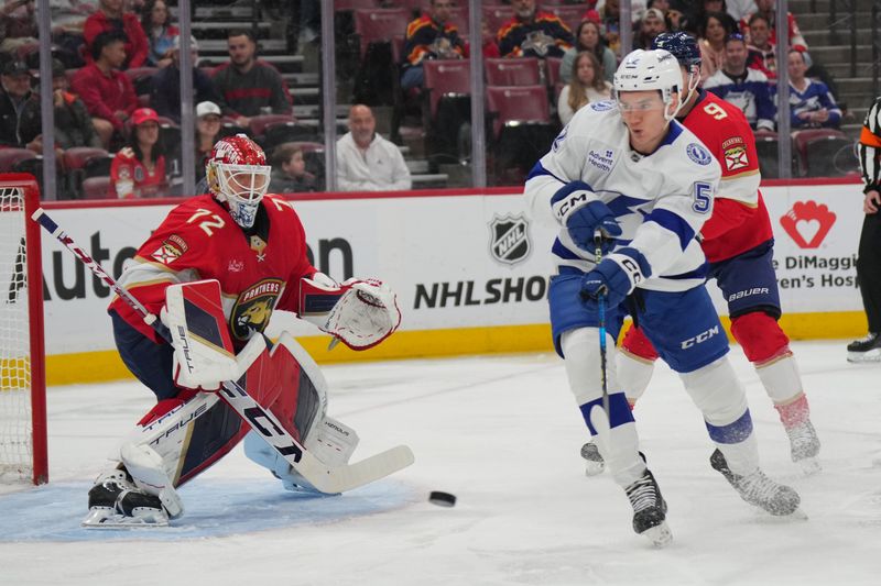 Sep 30, 2024; Sunrise, Florida, USA; Tampa Bay Lightning right wing Maxim Groshev (52) tips a shot toward Florida Panthers goaltender Sergei Bobrovsky (72) during the first period at Amerant Bank Arena. Mandatory Credit: Jim Rassol-Imagn Images