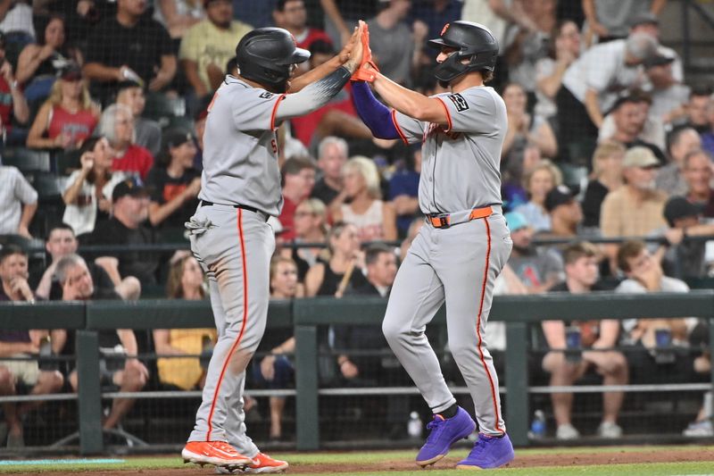 Jun 30, 2025; Phoenix, Arizona, USA;  San Francisco Giants shortstop Willy Adames (2) and first base Dominic Smith (7) celebrate after scoring in the seventh inning against the Arizona Diamondbacks at Chase Field. Mandatory Credit: Matt Kartozian-Imagn Images