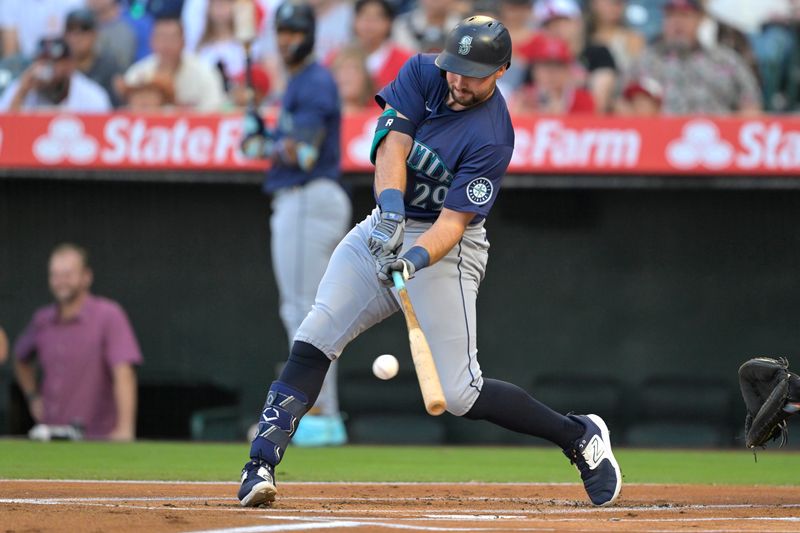 Jul 13, 2024; Anaheim, California, USA;  Cal Raleigh #29 of the Seattle Mariners singles in the first inning against the Los Angeles Angels at Angel Stadium. Mandatory Credit: Jayne Kamin-Oncea-USA TODAY Sports