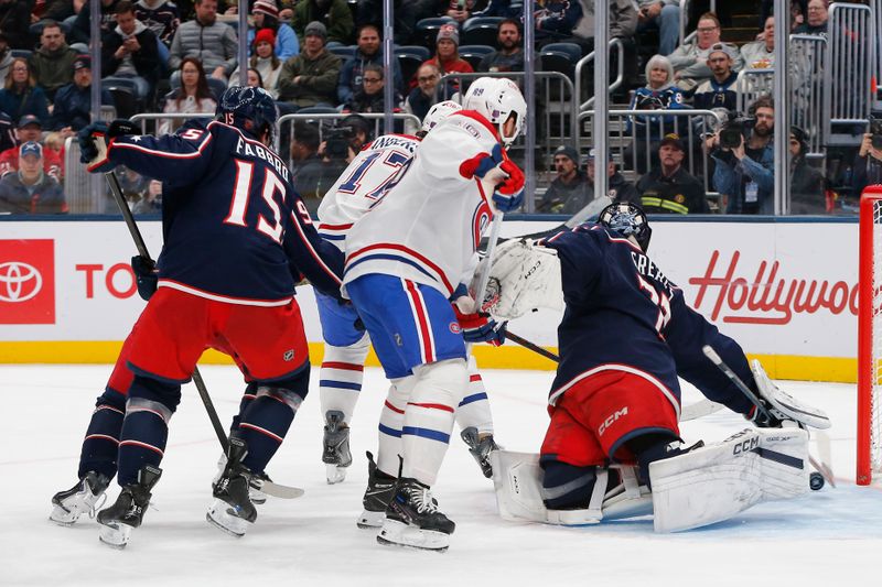 Nov 17, 2025; Columbus, Ohio, USA; Montreal Canadiens right wing Josh Anderson (17) scores a goal under the stick of Columbus Blue Jackets goalie Jet Greaves (73) during the third period at Nationwide Arena. Mandatory Credit: Russell LaBounty-Imagn Images