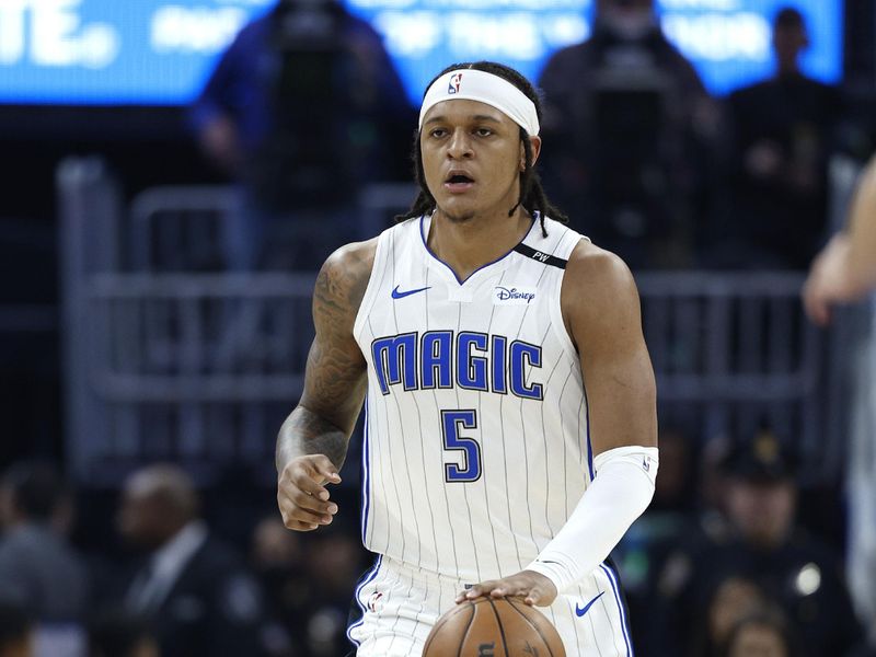 SAN FRANCISCO, CALIFORNIA - FEBRUARY 03: Paolo Banchero #5 of the Orlando Magic dribbles the ball up court agains the Golden State Warriors during the first half of an NBA basketball game at Chase Center on February 03, 2025 in San Francisco, California. NOTE TO USER: User expressly acknowledges and agrees that, by downloading and or using this photograph, User is consenting to the terms and conditions of the Getty Images License Agreement.  (Photo by Thearon W. Henderson/Getty Images)