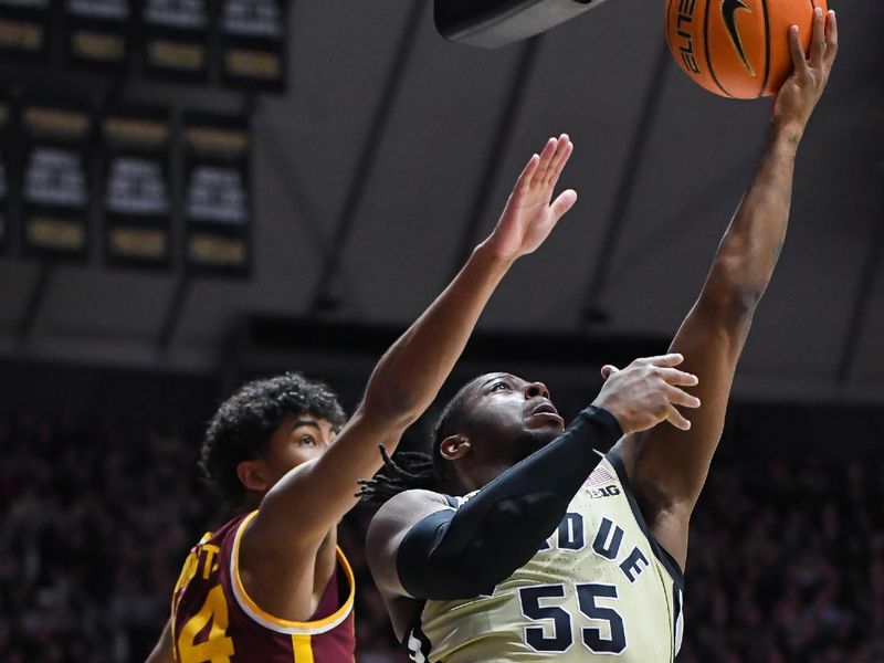 Feb 15, 2024; West Lafayette, Indiana, USA; Purdue Boilermakers guard Lance Jones (55) goes to the basket past Minnesota Golden Gophers guard Cam Christie (24) during the second half at Mackey Arena. Mandatory Credit: Robert Goddin-USA TODAY Sports