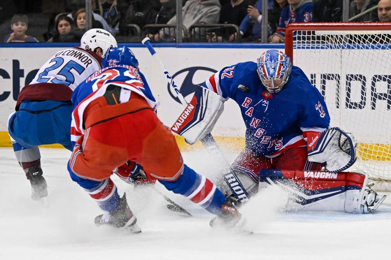 Feb 5, 2024; New York, New York, USA;  New York Rangers goaltender Jonathan Quick (32) makes a save on Colorado Avalanche right wing Logan O'Connor (25) during the second period at Madison Square Garden. Mandatory Credit: Dennis Schneidler-USA TODAY Sports