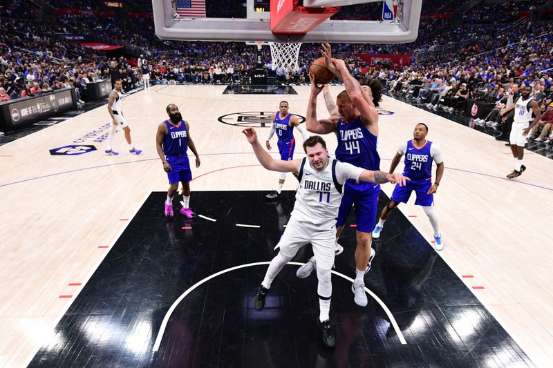 LOS ANGELES, CA - APRIL 21:  Mason Plumlee #44 of the LA Clippers grabs a rebound during the game against the Dallas Mavericks during Round 1 Game 1 of the 2024 NBA Playoffs on April 21, 2024 at Crypto.Com Arena in Los Angeles, California. NOTE TO USER: User expressly acknowledges and agrees that, by downloading and/or using this Photograph, user is consenting to the terms and conditions of the Getty Images License Agreement. Mandatory Copyright Notice: Copyright 2024 NBAE (Photo by Adam Pantozzi/NBAE via Getty Images)