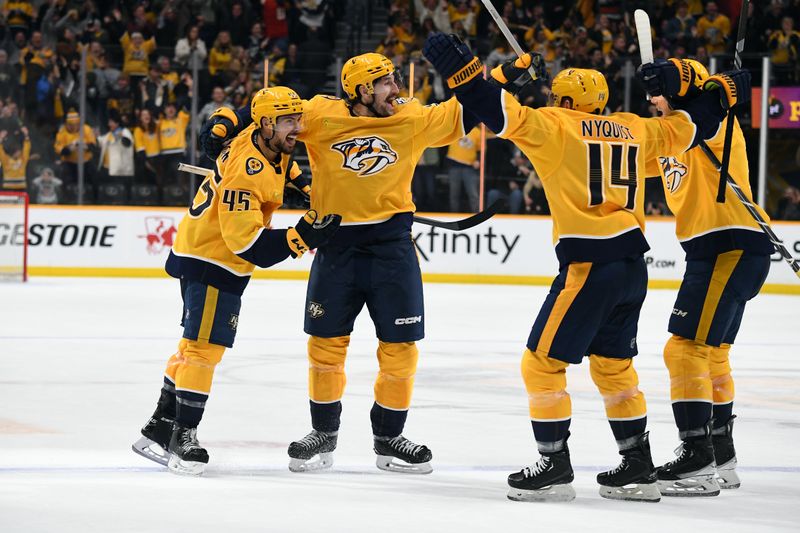 Jan 13, 2024; Nashville, Tennessee, USA; Nashville Predators defenseman Alexandre Carrier (45) celebrates with teammates after scoring the game-winning goal during the third period against the New York Islanders at Bridgestone Arena. Mandatory Credit: Christopher Hanewinckel-USA TODAY Sports