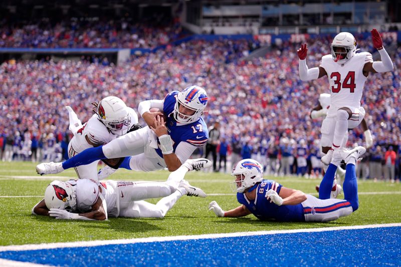 Buffalo Bills quarterback Josh Allen (17) scores a touchdown against the Arizona Cardinals as Bills tight end Dalton Kincaid (86) and Arizona Cardinals safety Jalen Thompson (34) look on during the first half of an NFL football game Sunday, Sept. 8, 2024, in Orchard Park, N.Y. (AP Photo/Matt Slocum)