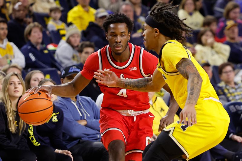 Jan 15, 2024; Ann Arbor, Michigan, USA; Ohio State Buckeyes guard Dale Bonner (4) dribbles as Michigan Wolverines guard Dug McDaniel (0) defends in the second half at Crisler Center. Mandatory Credit: Rick Osentoski-USA TODAY Sports