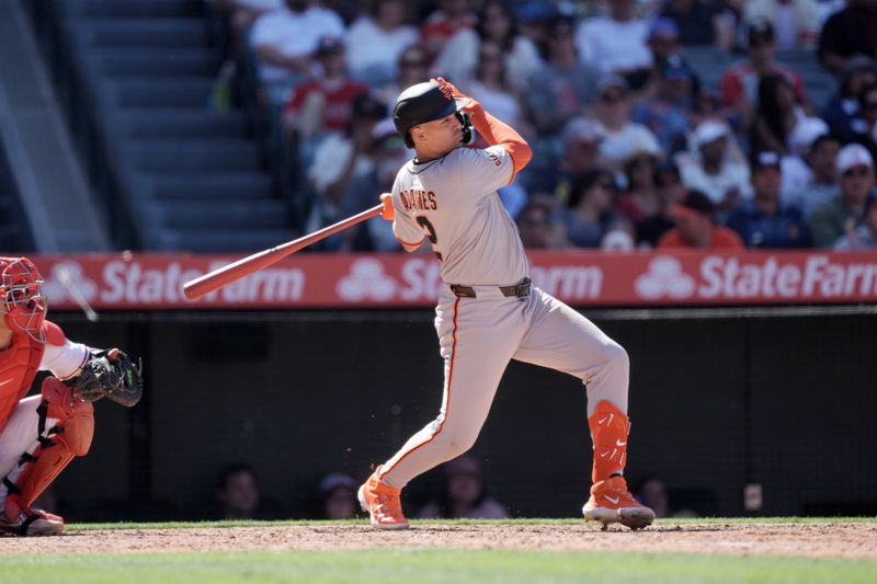 Apr 20, 2025; Anaheim, California, USA; San Francisco Giants shortstop Willy Adames (2) hits a RBI single in the eighth inning against the Los Angeles Angels at Angel Stadium. Mandatory Credit: Kirby Lee-Imagn Images