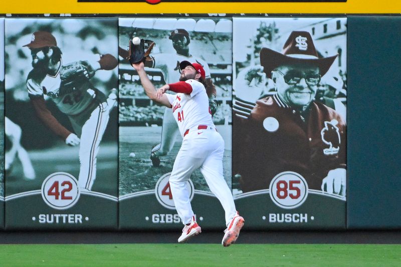 Jul 29, 2024; St. Louis, Missouri, USA;  St. Louis Cardinals left fielder Alec Burleson (41) leaps and catches a fly ball against the Texas Rangers during the third inning at Busch Stadium. Mandatory Credit: Jeff Curry-USA TODAY Sports