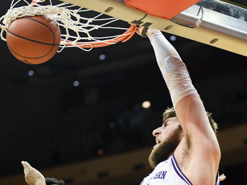 Feb 18, 2024; Bloomington, Indiana, USA;  Northwestern Wildcats center Matthew Nicholson (34) dunks the ball past Indiana Hoosiers forward Anthony Walker (4) during the second half at Simon Skjodt Assembly Hall. Mandatory Credit: Robert Goddin-USA TODAY Sports